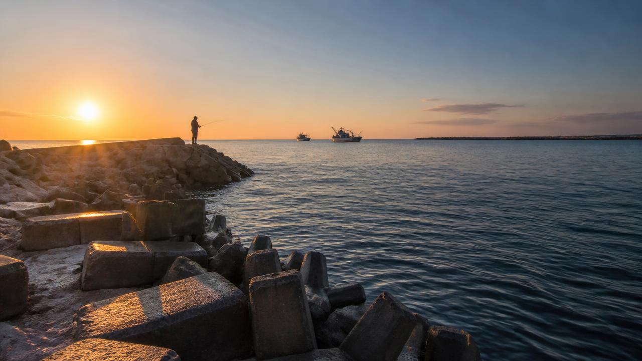 Rocky breakwater and calm harbour water typical of good LRF fishing ground in Cyprus