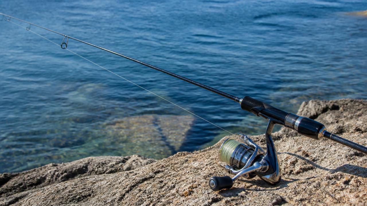 An LRF spinning rod and small reel leaning against a rail on a Cyprus harbour wall